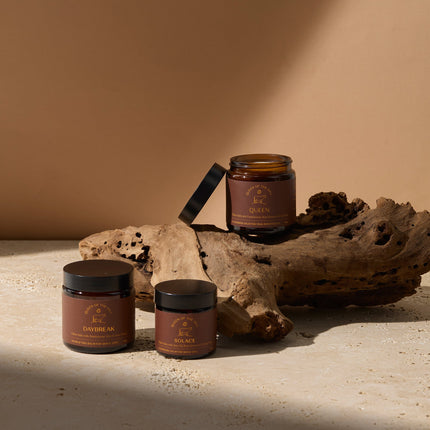 A collection of three products in the Daily Rituals range sitting on driftwood
