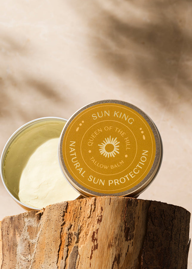 Sun King natural sun protection balm on a wooden block with a neutral background
